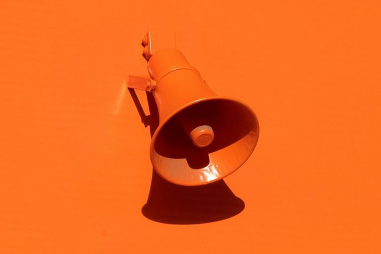 orange megaphone on orange wall